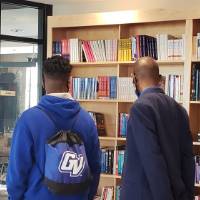 Students browsing a bookshelf